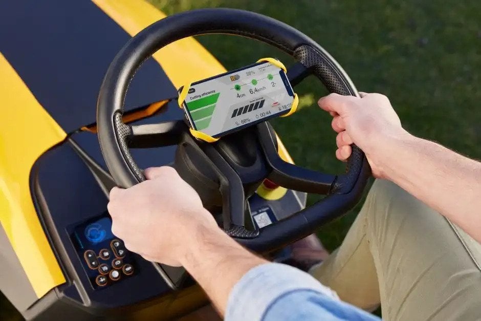 Stiga Estate 798e - Steering Wheel Holding Driver's Mobile Phone Showing Tractor Information.