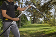 Stiga SPH 900 AE 48v Cordless Long-Reach Hedgetrimmer - In Use with Cutter Head at 90°.