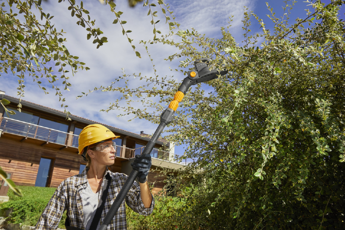 Stiga SPH 700 AE 48v Cordless Long-Reach Hedgetrimmer - In Use with Cutter Head Angled.