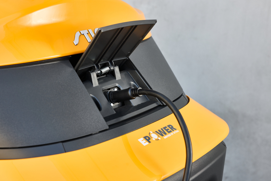 Stiga Gyro 700e ‘Drive-by-Wire’ Electric Battery-Powered Axial Ride-On Lawnmower - Charging Port with Cover Open and Power Lead Plugged-In.